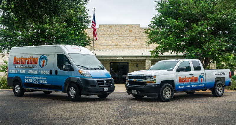 restoration 1 truck and van outside building