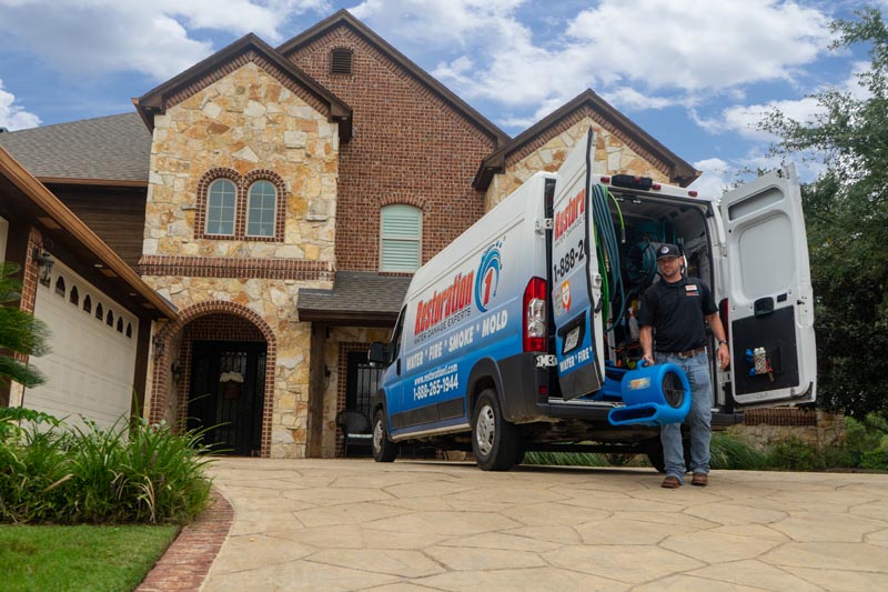 technician taking fan into home