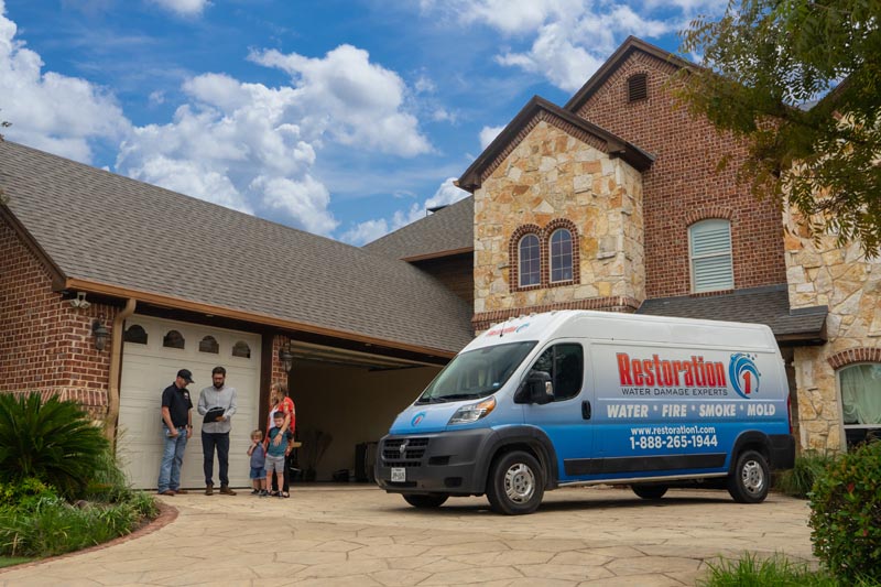 technician outside home with family