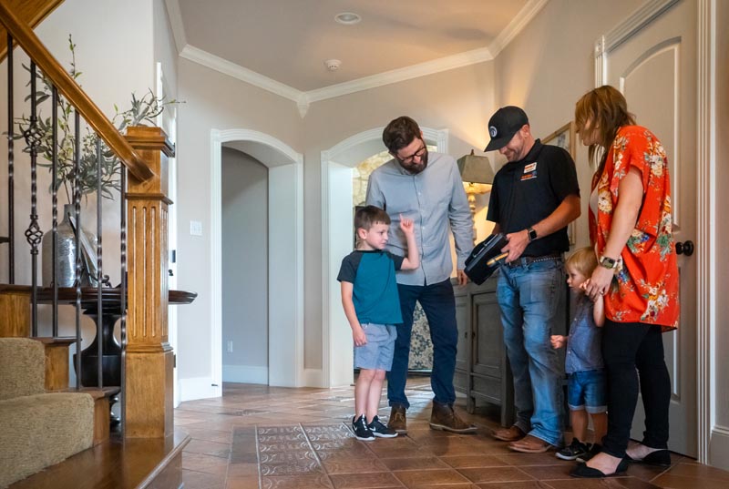 Technician showing family information on clipboard